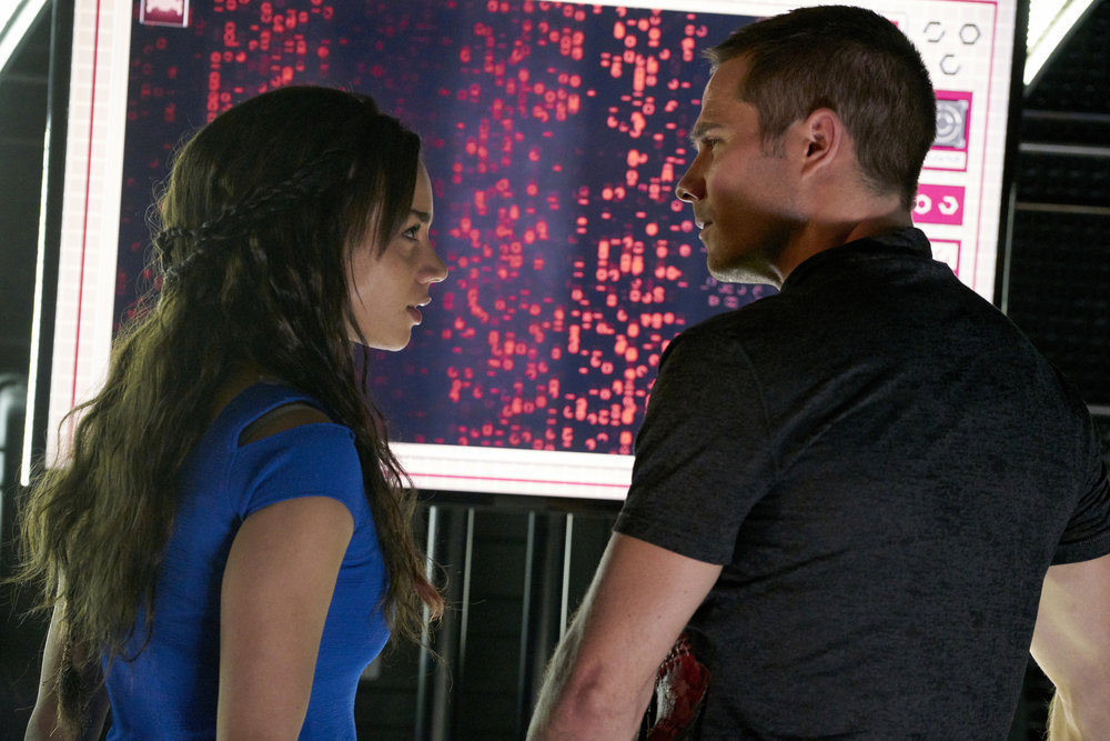 KILLJOYS -- "Meet The Parents" Episode 205 -- Pictured: (l-r) Hannah John-Kamen as Dutch, Luke Macfarlane as D'avin -- (Photo by: Steve Wilkie/Syfy/Killjoys II Productions Limited)