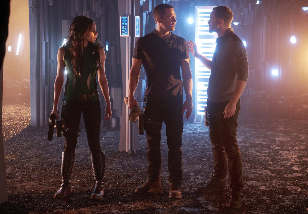 KILLJOYS -- "I Love Lucy" Episode 206 -- Pictured: (l-r) Hannah John-Kamen as Dutch, Luke Macfarlane as D'Avin, Aaron Ashmore as John -- (Photo by: Steve Wilkie/Syfy/Killjoys II Productions Limited)